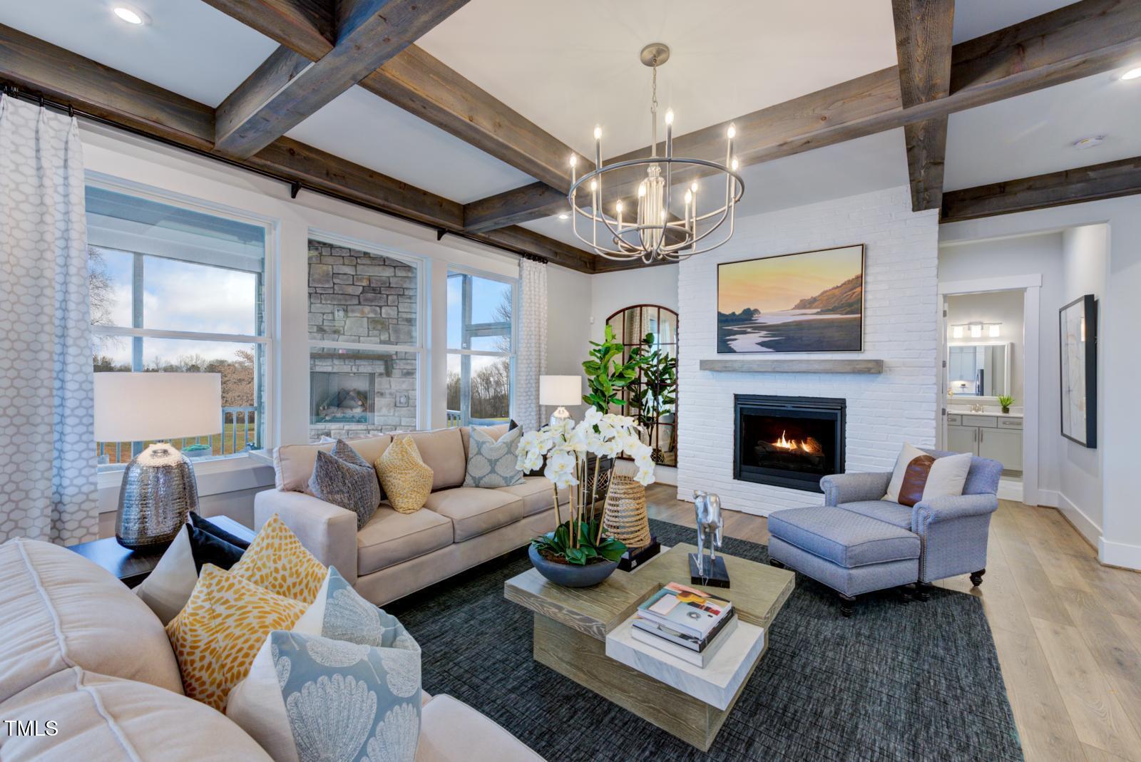 149 Brandy Mill Pittsboro, NC 27312 - Photo 53 of 69 a living room with furniture a chandelier and a fireplace