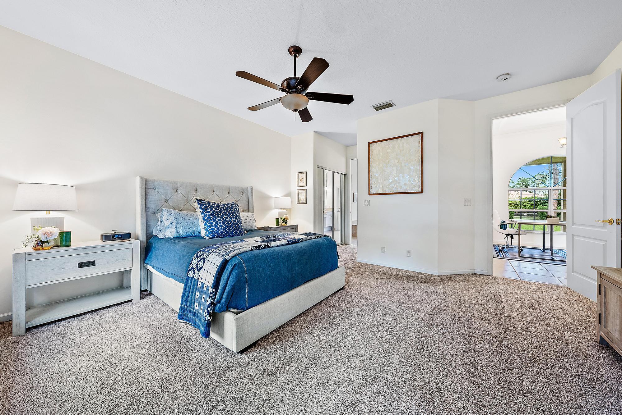 15644 Billy Goat Lane Jupiter, FL 33478 - Photo 17 of 39 a spacious bedroom with a bed and a large window
