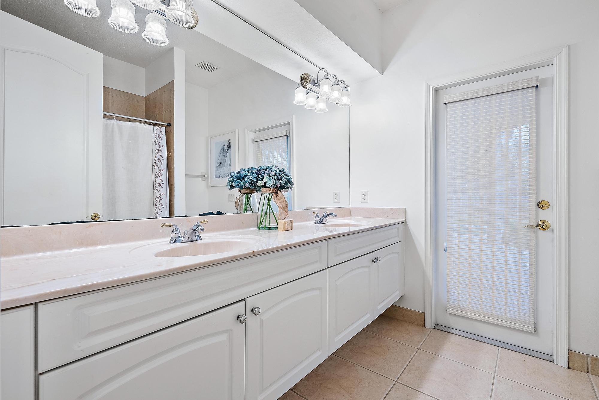 15644 Billy Goat Lane Jupiter, FL 33478 - Photo 22 of 39 a bathroom with a double vanity sink and a mirror