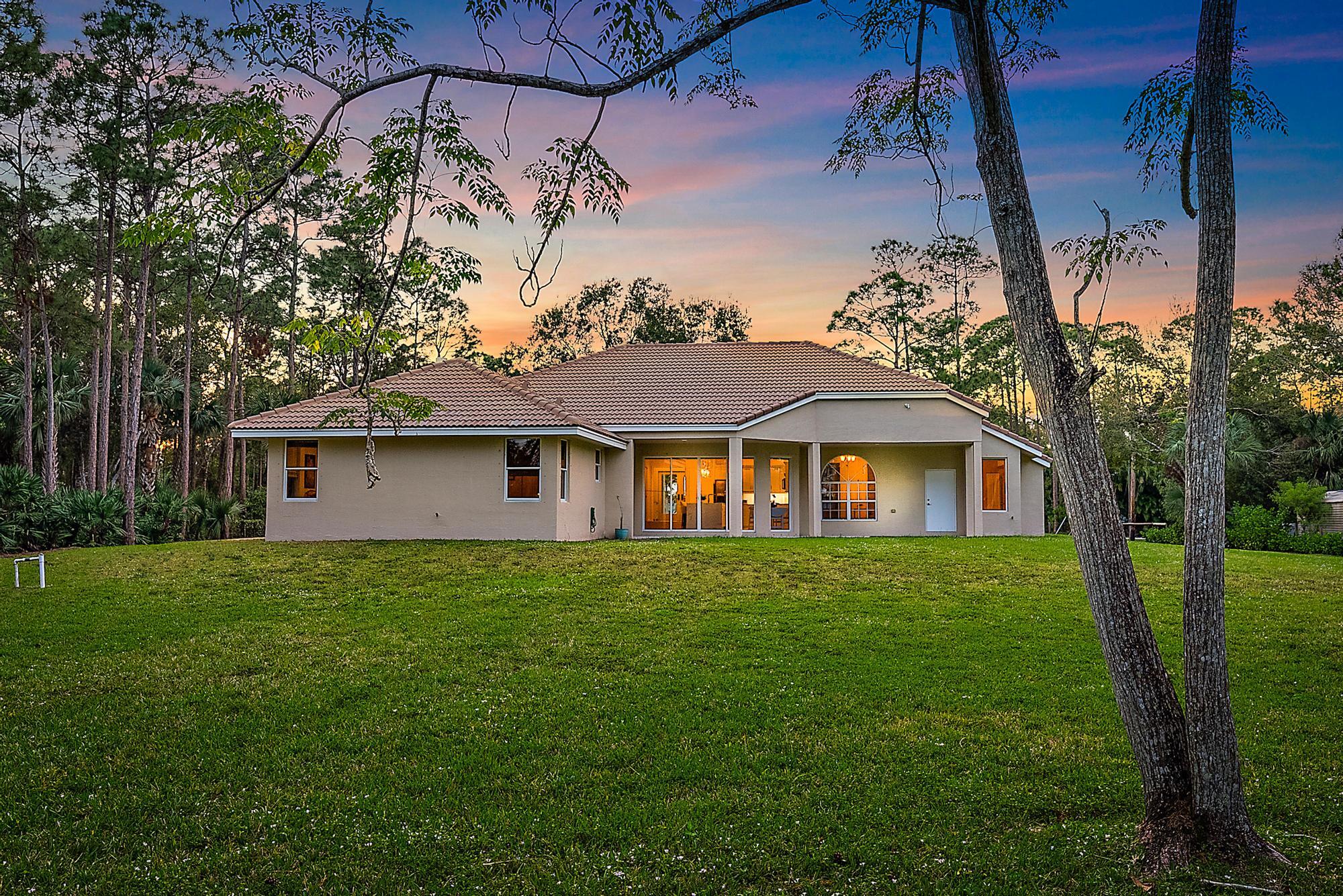 15644 Billy Goat Lane Jupiter, FL 33478 - Photo 30 of 39 a front view of a house with garden