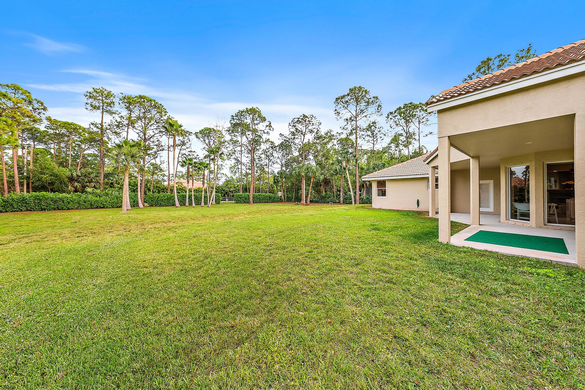 15644 Billy Goat Lane Jupiter, FL 33478 - Photo 37 of 39 a front view of a house with garden