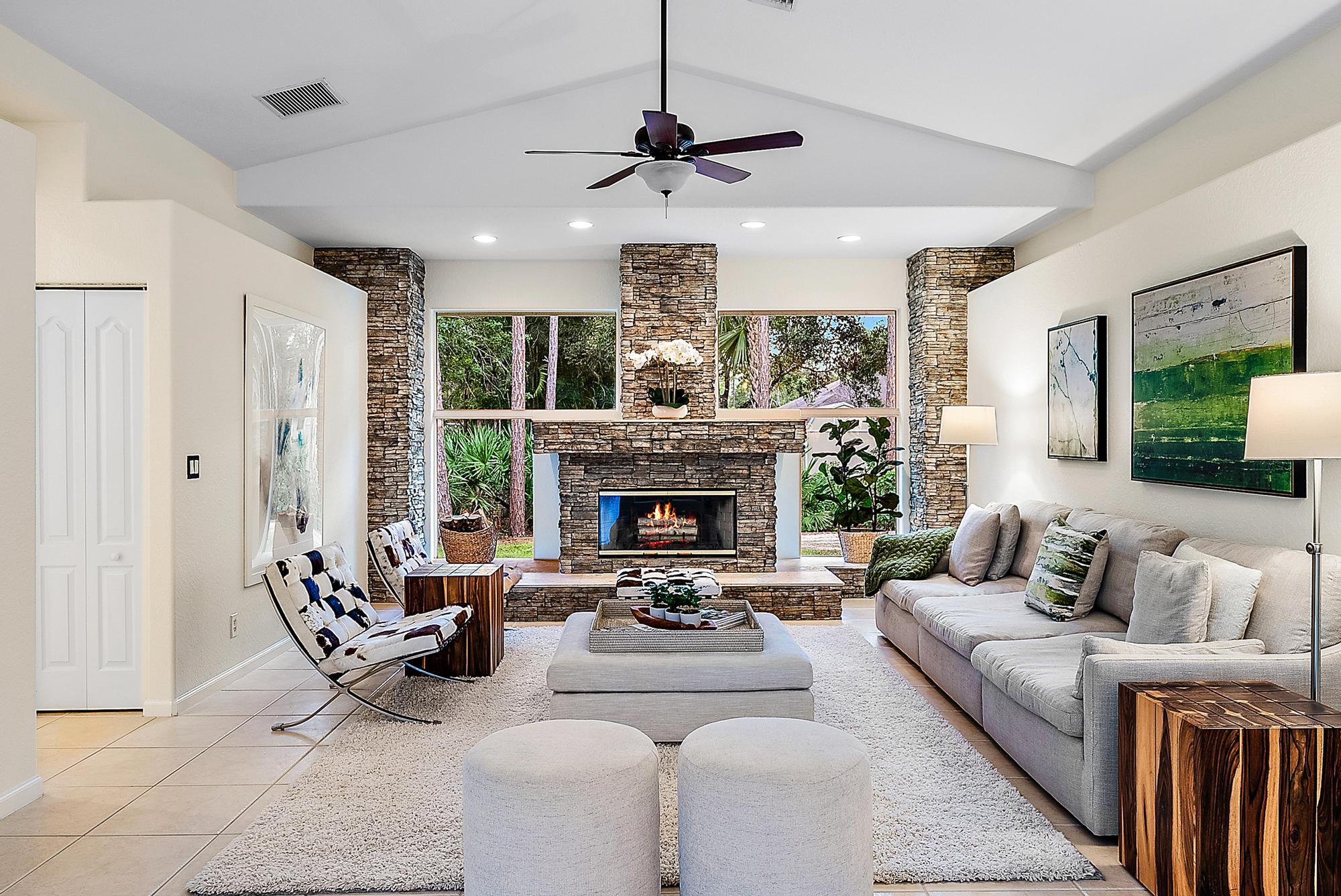15644 Billy Goat Lane Jupiter, FL 33478 - Photo 10 of 39 a living room with furniture a fireplace and a chandelier