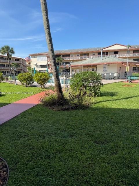 5300 Washington Street, Unit P136 Hollywood, FL 33021 - Photo 17 of 21 a view of a garden with a building in the background