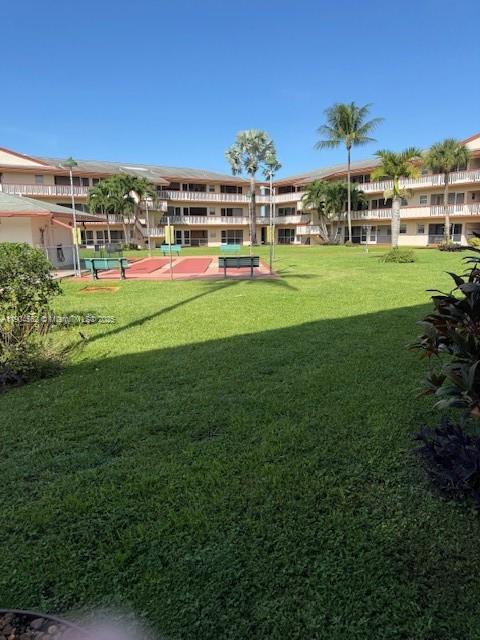 5300 Washington Street, Unit P136 Hollywood, FL 33021 - Photo 21 of 21 a view of a building with a big yard and large trees
