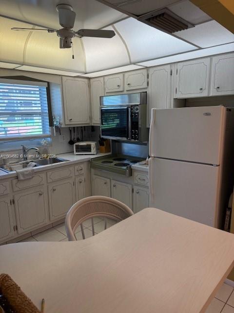 5300 Washington Street, Unit P136 Hollywood, FL 33021 - Photo 4 of 21 a kitchen with a sink a refrigerator and cabinets