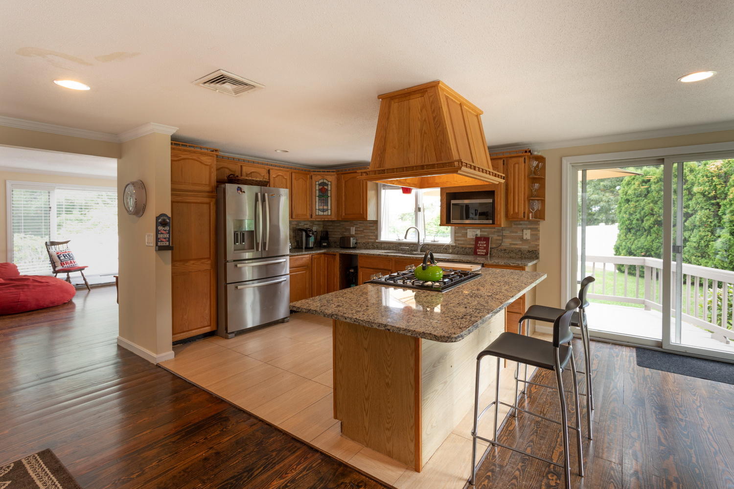 104 Goose Point Road Centerville, MA 02601 - Photo 14 of 41 a kitchen with stainless steel appliances granite countertop a refrigerator a stove and a wooden floor