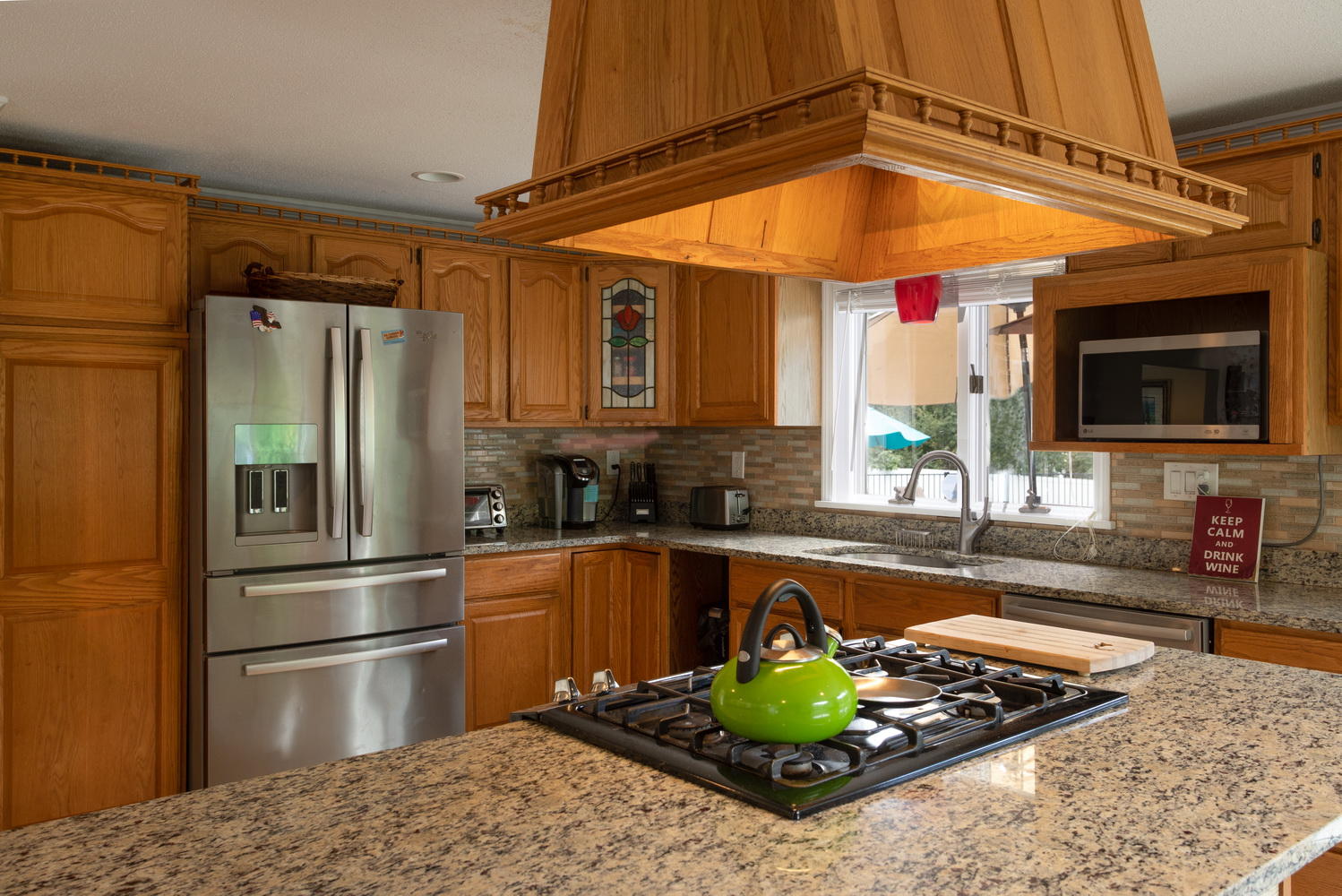 104 Goose Point Road Centerville, MA 02601 - Photo 15 of 41 a kitchen with stainless steel appliances granite countertop a refrigerator and a stove top oven