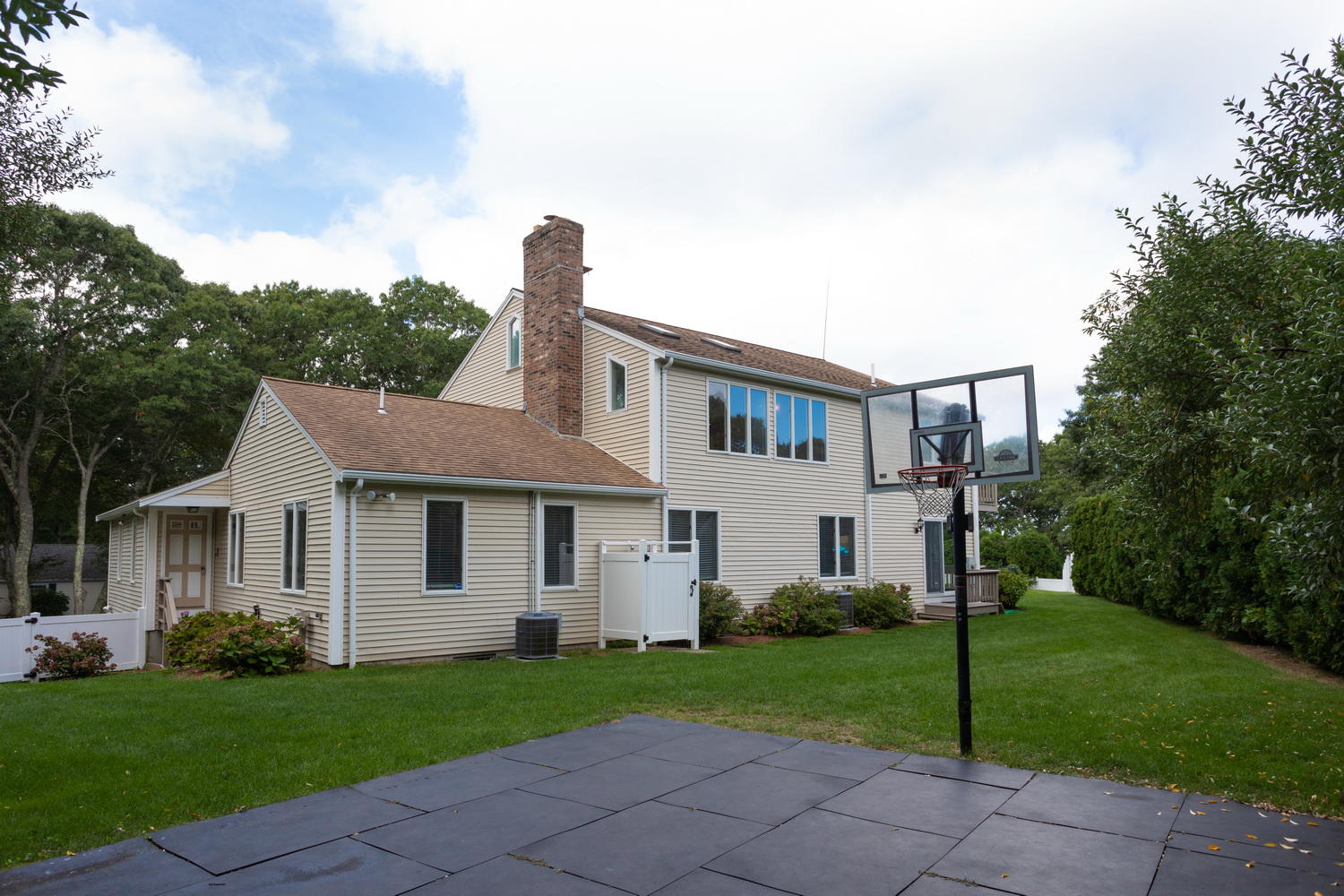 104 Goose Point Road Centerville, MA 02601 - Photo 7 of 41 a front view of a house with a yard