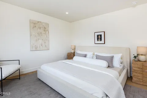 a bedroom with a bed and a lamp on table