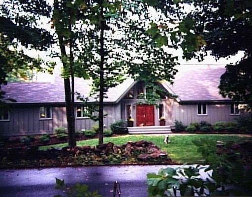 100 Lincoln Lane Ridgefield, CT 06877 - Photo 1 of 1 a front view of a house with a garden and plants