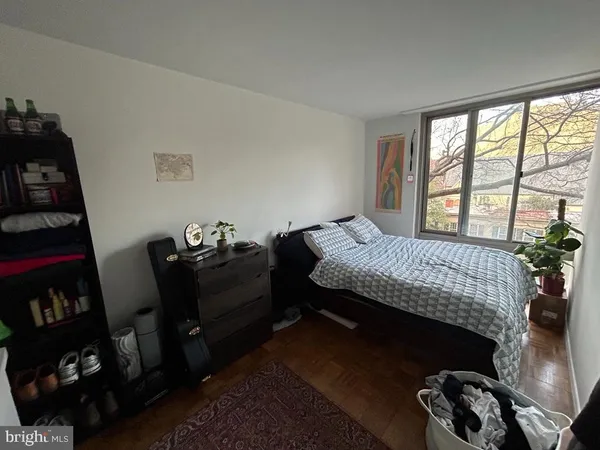 a kitchen with a refrigerator a stove top oven and white cabinets