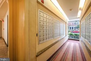 a living room with furniture a flat screen tv and floor to ceiling window