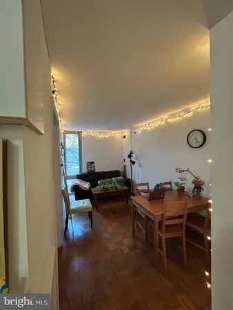 a kitchen with a refrigerator a stove top oven and white cabinets