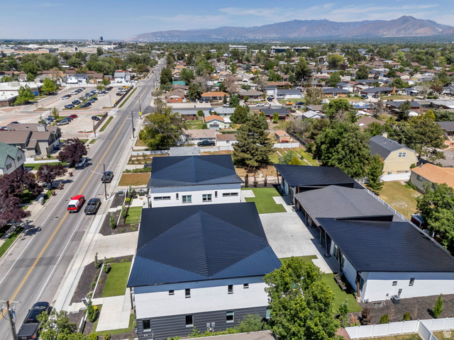 7045 South 300 East Midvale, UT 84047 - Photo 48 of 49 Modern residential properties featuring striking black metal roofing and contemporary white and dark gray exteriors