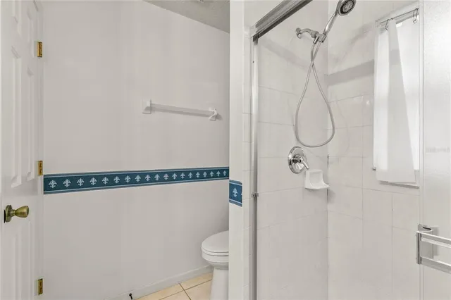 a bathroom that has a shower vanity and toilet