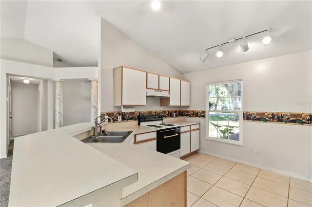 a kitchen with a stove a sink and a refrigerator