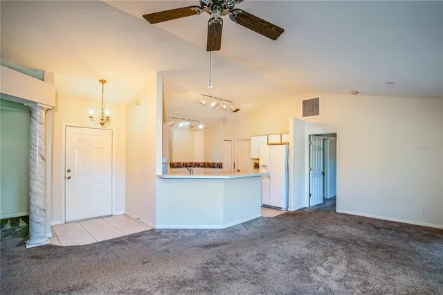 a view of a kitchen with a sink and a refrigerator