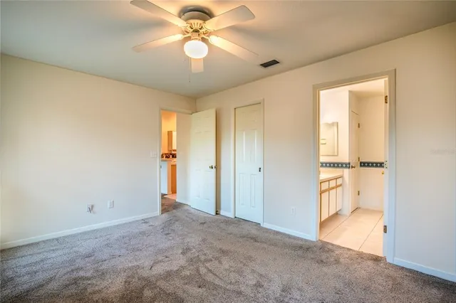 a view of an empty room and a ceiling fan