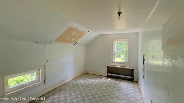 a view of empty room with window and fireplace