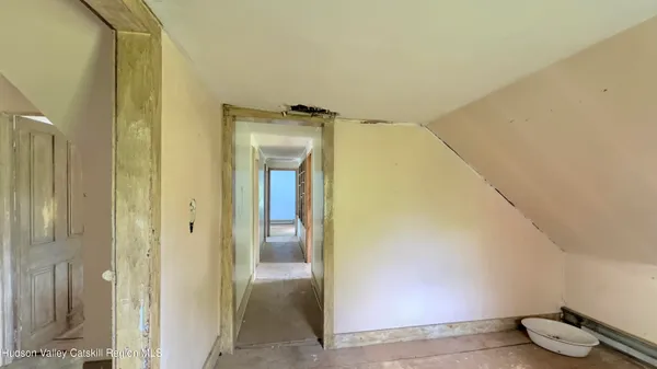 a view of a hallway with wooden shelves