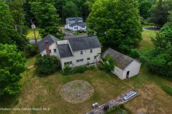 an aerial view of a house with a yard