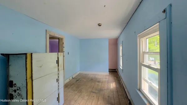 a view of a kitchen with wooden floor and a refrigerator