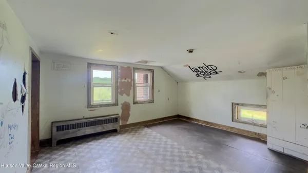 a view of room with window and a ceiling fan