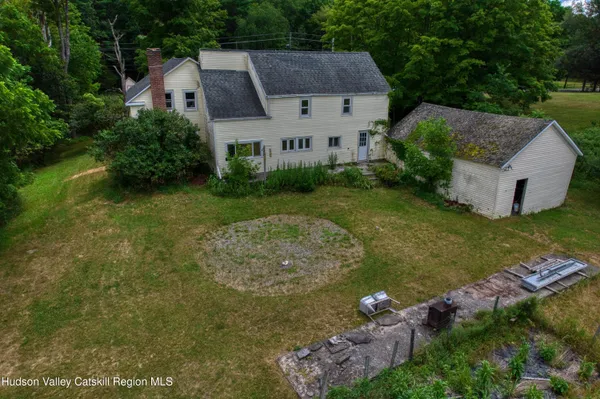 an aerial view of a house with a yard