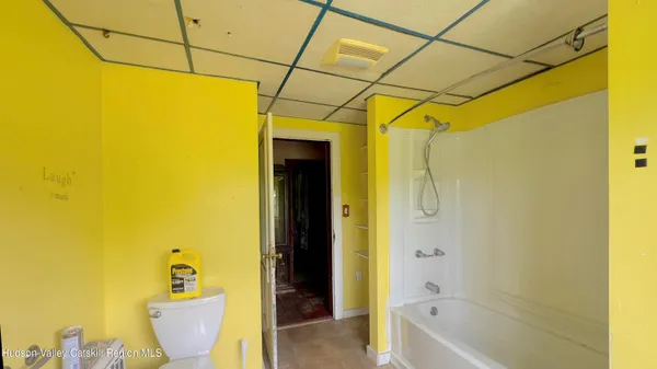 a bathroom with a bathtub and toilet