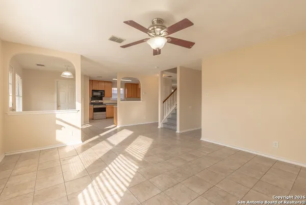 a view of a livingroom with a furniture & a ceiling fan