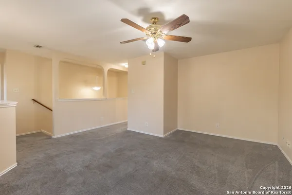 an empty room with closet and windows