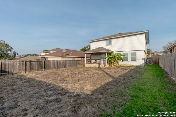 a view of house with yard and sitting area