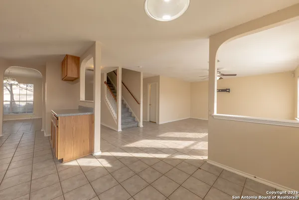 a view of a livingroom with wooden floor and stairs