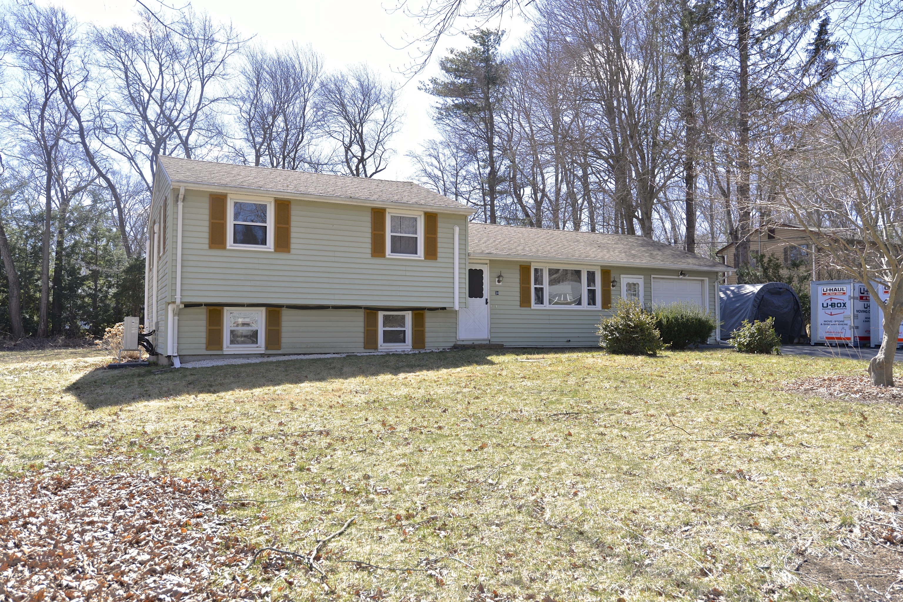 a front view of a house with a yard covered in snow