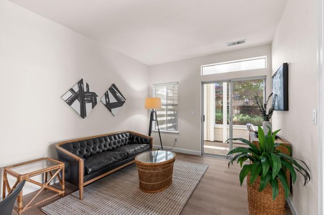 a living room with furniture and a rug