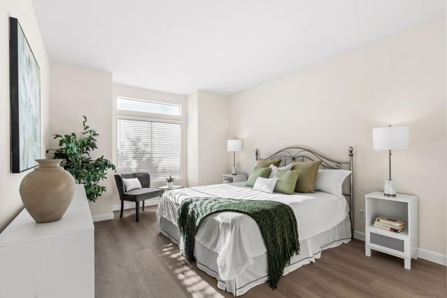 a bedroom with a bed and a painting on the wall