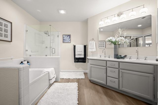 a white bath tub sitting next to a white sink