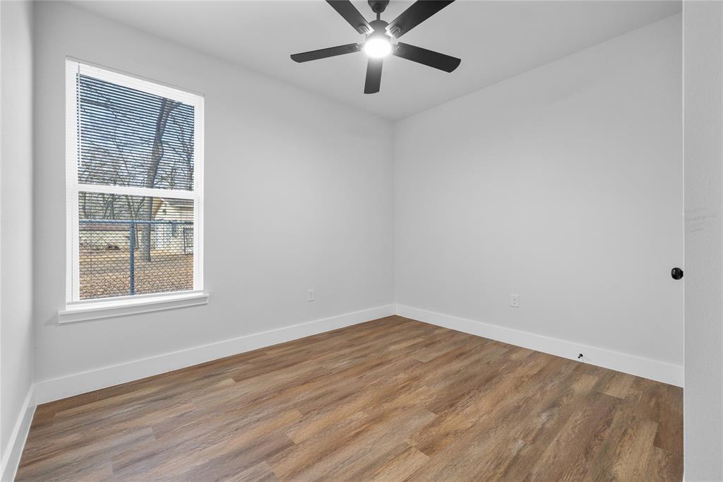 120 Red Bird Lane Mabank, TX 75156 - Photo 12 of 23 an empty room with a window and a ceiling fan