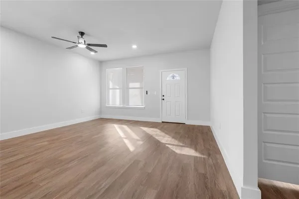 wooden floor in an empty room with a window