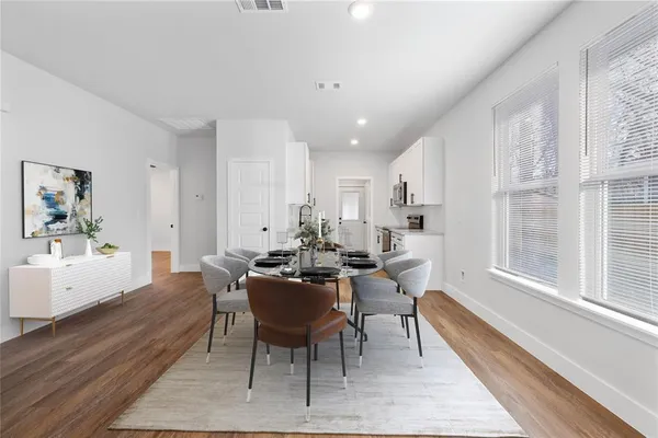 a view of a dining room with furniture window and wooden floor