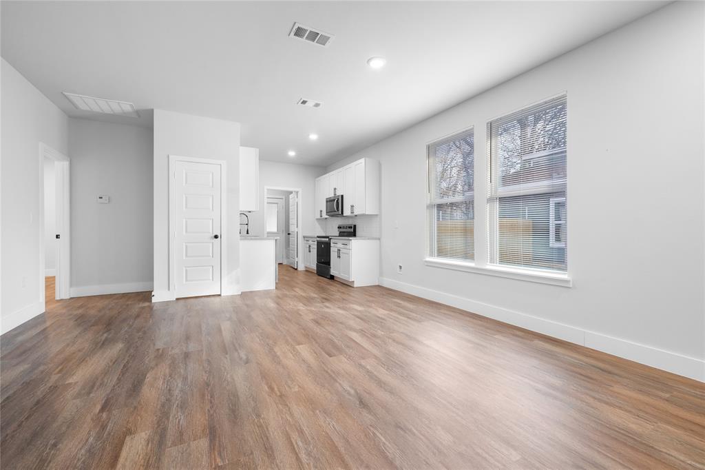 120 Red Bird Lane Mabank, TX 75156 - Photo 3 of 23 a view of empty room with wooden floor and kitchen view