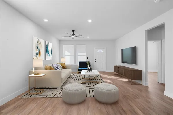 a living room with furniture and a flat screen tv