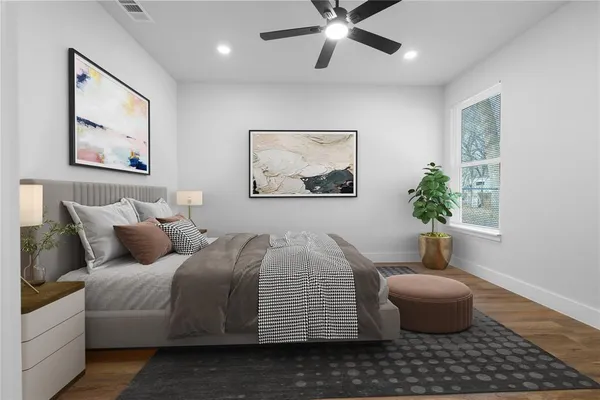 a bedroom with a bed and a painting on the wall