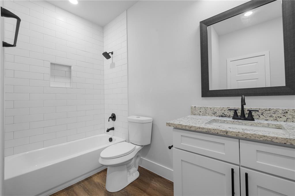 120 Red Bird Lane Mabank, TX 75156 - Photo 8 of 23 a bathroom with a granite countertop toilet a sink and a bathtub