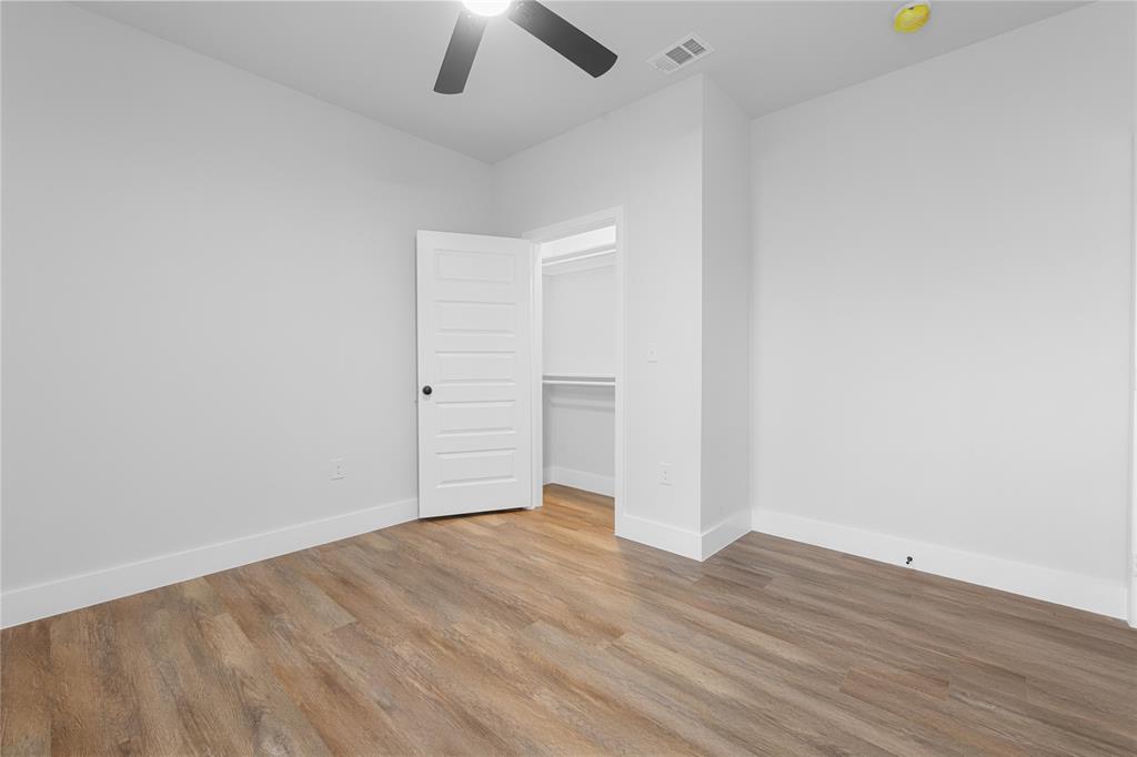 120 Red Bird Lane Mabank, TX 75156 - Photo 10 of 23 an empty room with wooden floor and ceiling fan