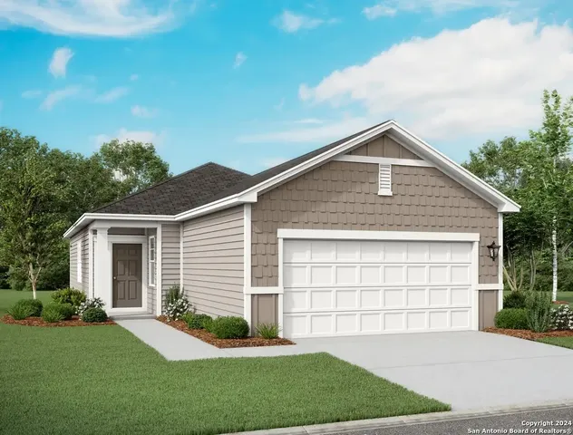 a front view of a house with a garden and yard