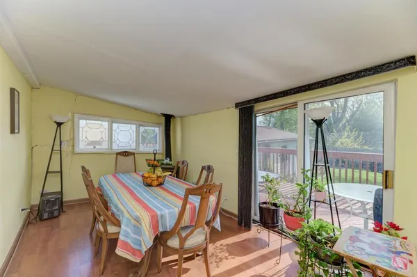 a dining room with furniture and wooden floor