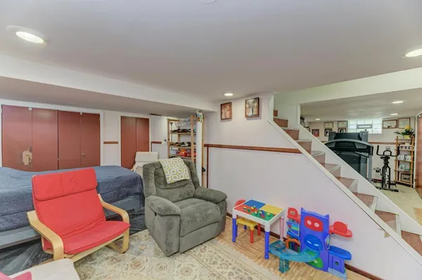 a living room with furniture and kitchen view