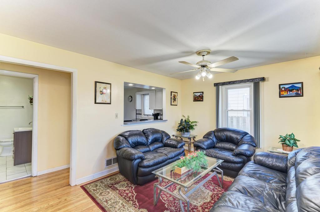 1431 North Hillside Avenue Berkeley, IL 60163 - Photo 2 of 29 a living room with furniture and a chandelier