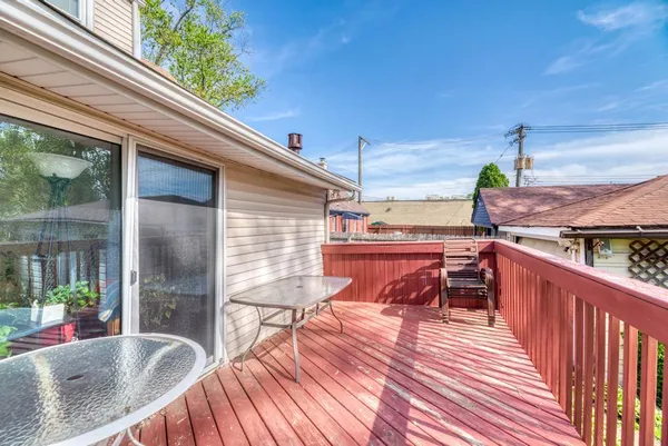 a balcony with furniture and wooden floor